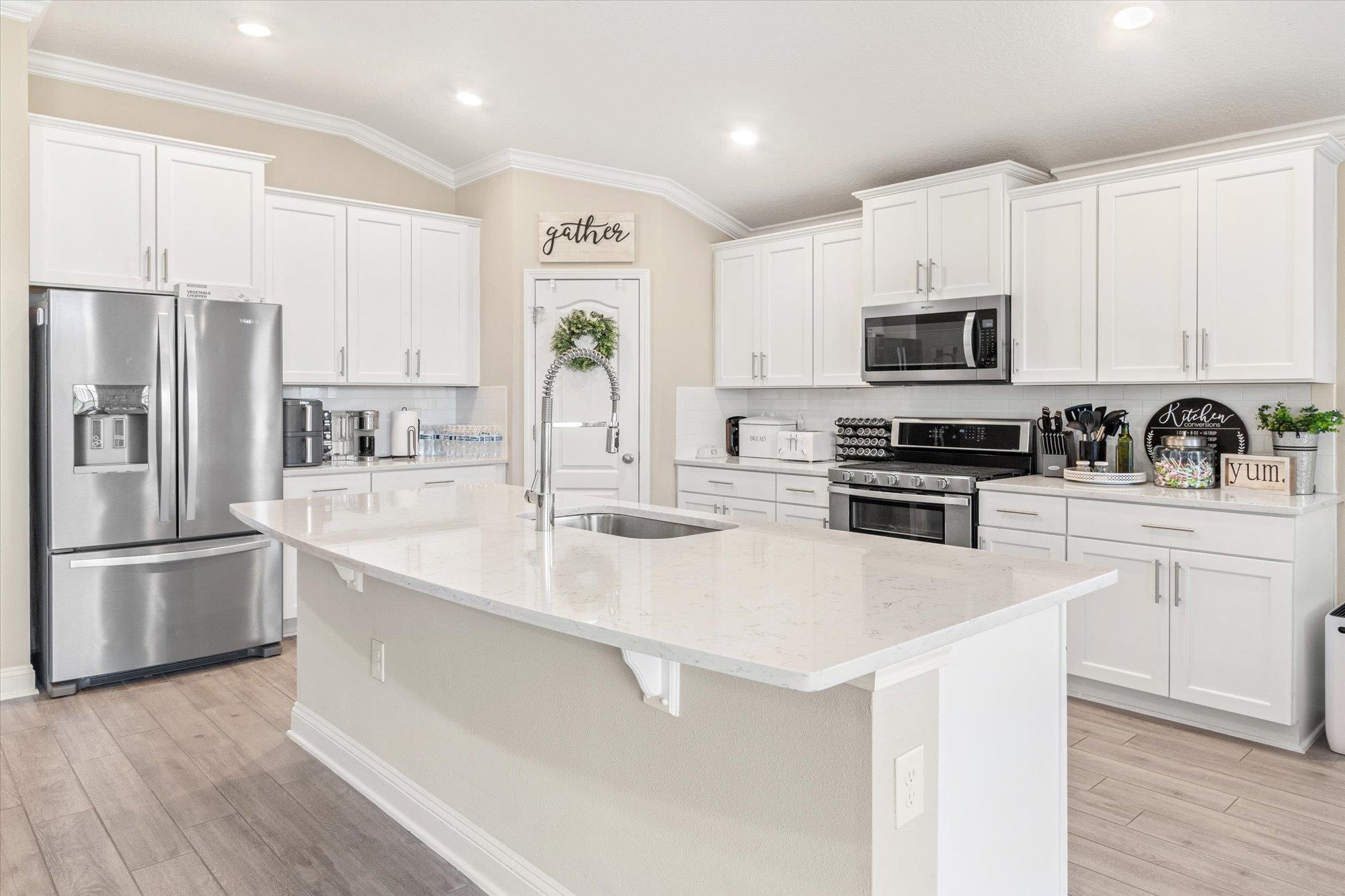 23 Alagon Way Street St. Augustine, FL 32084 - Photo 9 of 51 a kitchen with stainless steel appliances a sink a stove a microwave a refrigerator a sink and cabinets
