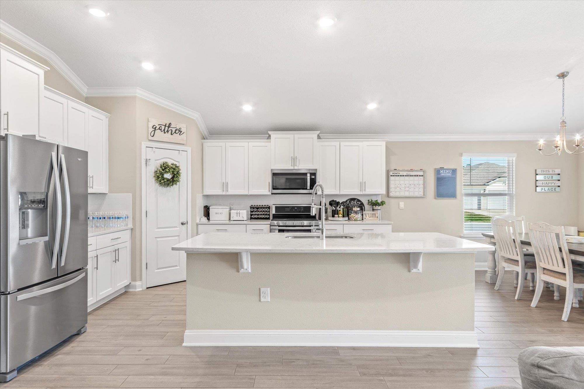 23 Alagon Way Street St. Augustine, FL 32084 - Photo 10 of 51 a large kitchen with stainless steel appliances granite countertop a large center island and a refrigerator