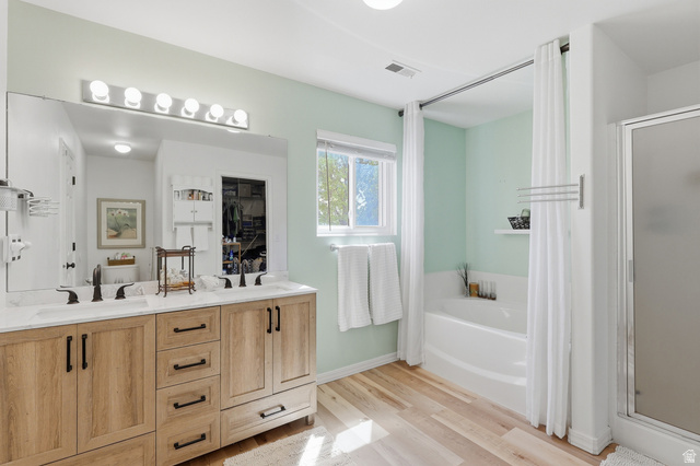 1652 West 800 South Lehi, UT 84043 - Photo 14 of 27 Full bath featuring double vanity, a shower stall, a garden tub, and light wood-style floors