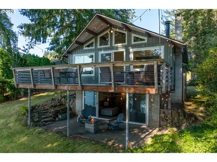 a view of house with a big yard and potted plants