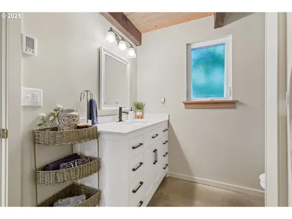 a bathroom with a sink toilet and mirror