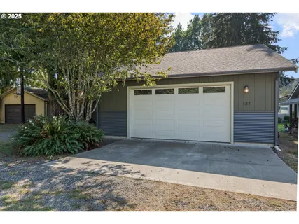 a aerial view of a house with a yard and garage