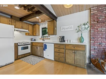 a kitchen with a stove a sink and a refrigerator
