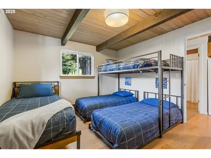 a bedroom with a bed a chandelier and window