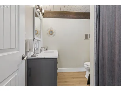 a bathroom with a sink a toilet and a mirror