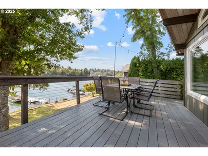 a outdoor view with a sitting space and large trees