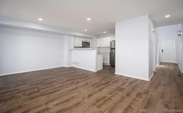 a view of a kitchen with a sink and a refrigerator