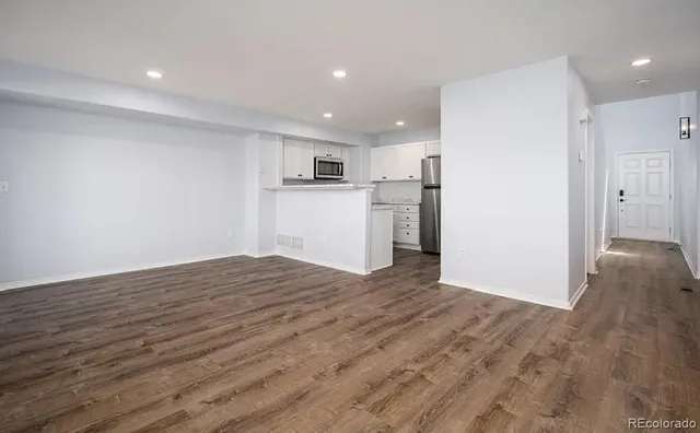 a view of a kitchen with a sink and a refrigerator