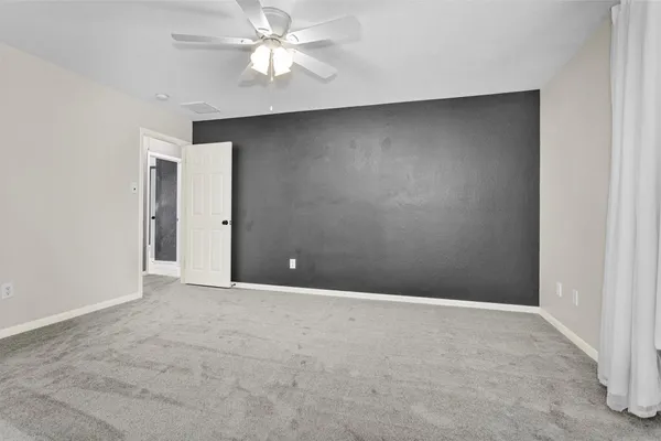 a view of an empty room with a bathroom