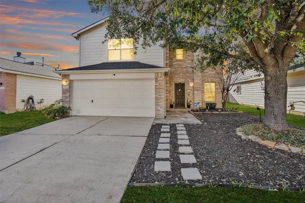 a front view of a house with a yard
