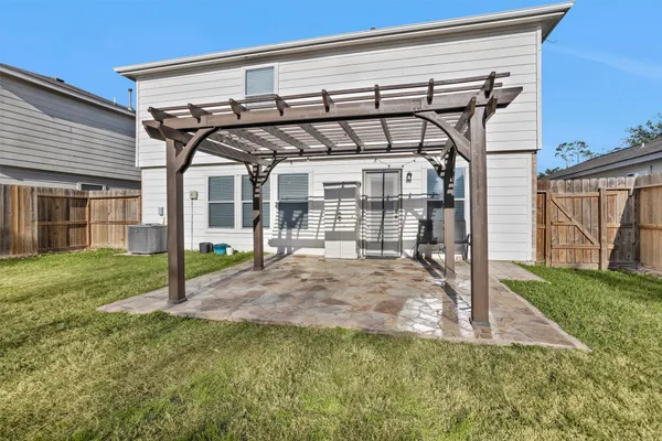 a view of a house with backyard and porch
