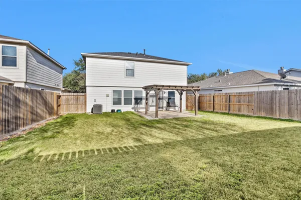 a view of a house with a yard and sitting area