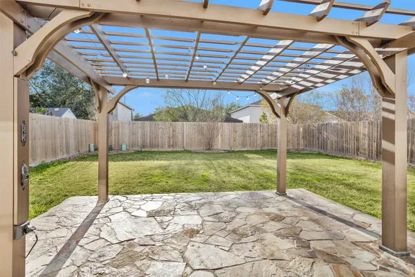 a view of a backyard with plants and a backyard