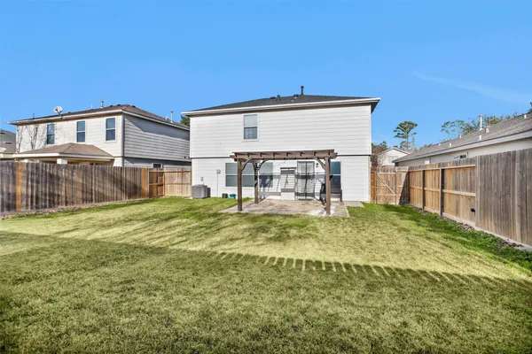a view of a house with a yard and sitting area