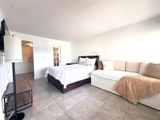 a spacious bedroom with a bed and window