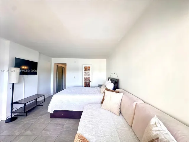 a kitchen with granite countertop a stove and white cabinets