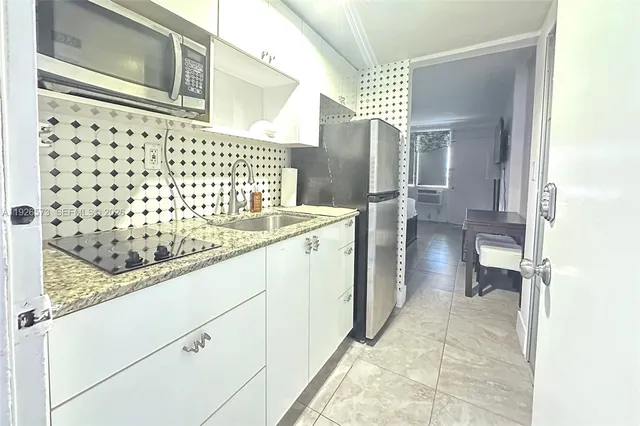 a white toilet sitting next to a small bathroom