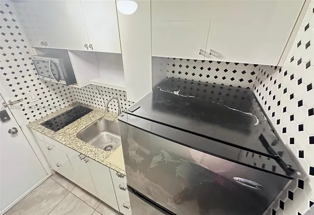 a close view of walk in closet with wooden floor