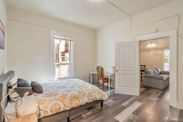 a bedroom with a bed and a couch