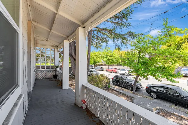 a view of a couches and table in the balcony