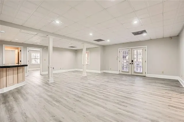 a view of a kitchen with wooden floor and a refrigerator