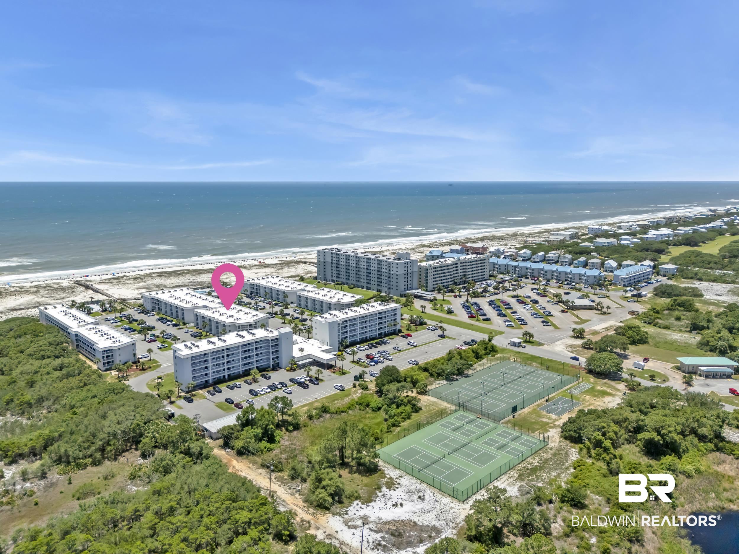 400 Plantation Road, Unit 2118 Gulf Shores, AL 36542 - Photo 54 of 59 Coastal condominium complex with multiple buildings, beachfront access, ample surface parking, and tennis courts