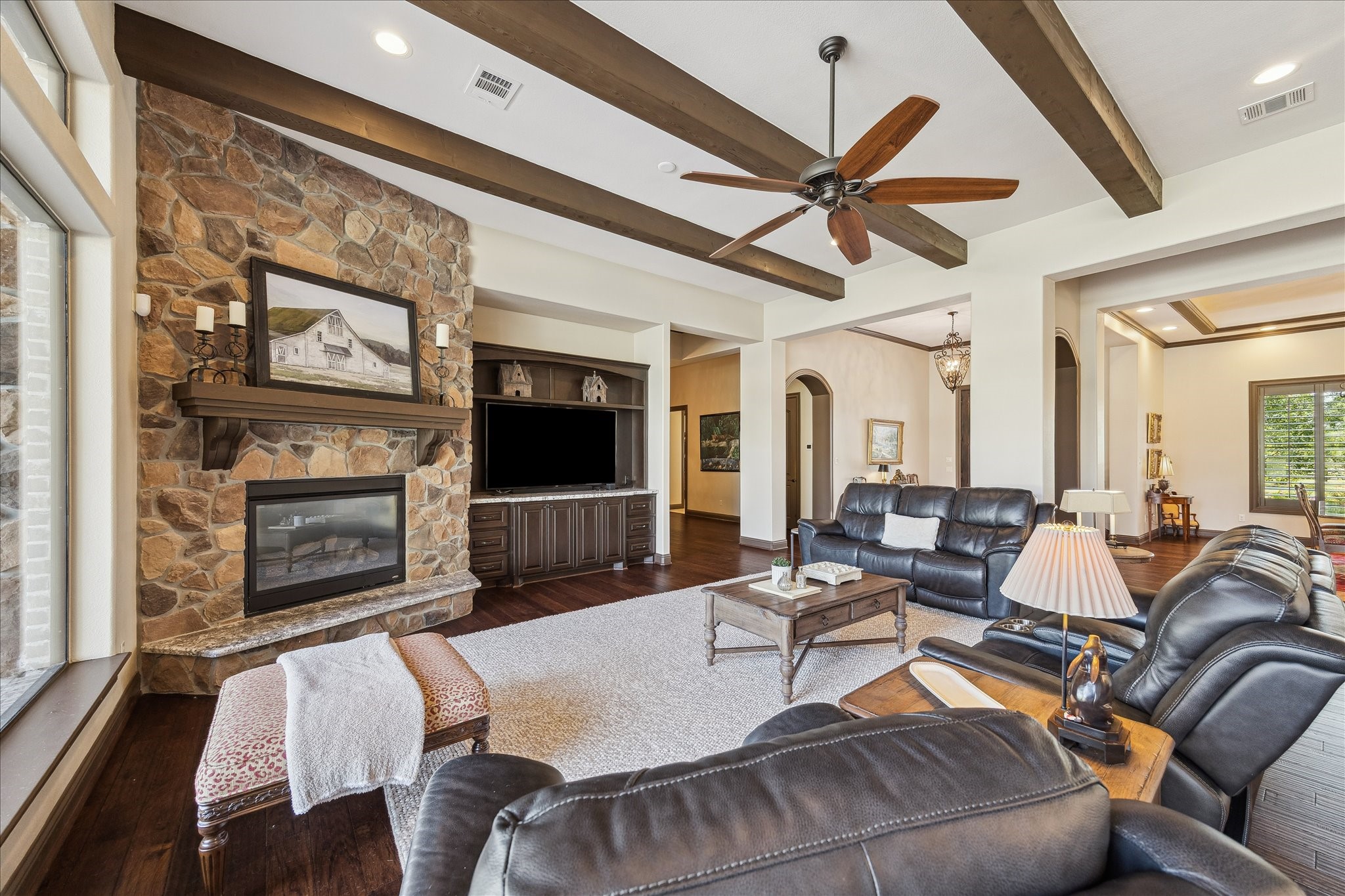 11 Willowcreek Ranch Road Tomball, TX 77377 - Photo 20 of 49 The family room space is warm and inviting. It is accented by a stone fireplace, custom built in cabinetry and wood beams.