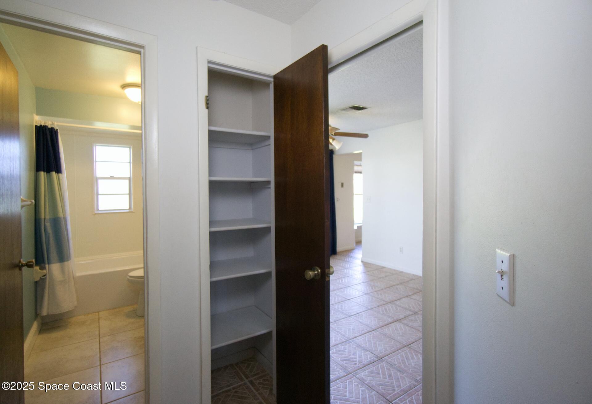 1980 Talloak Road Melbourne, FL 32935 - Photo 12 of 13 a view of a bathroom with a glass door