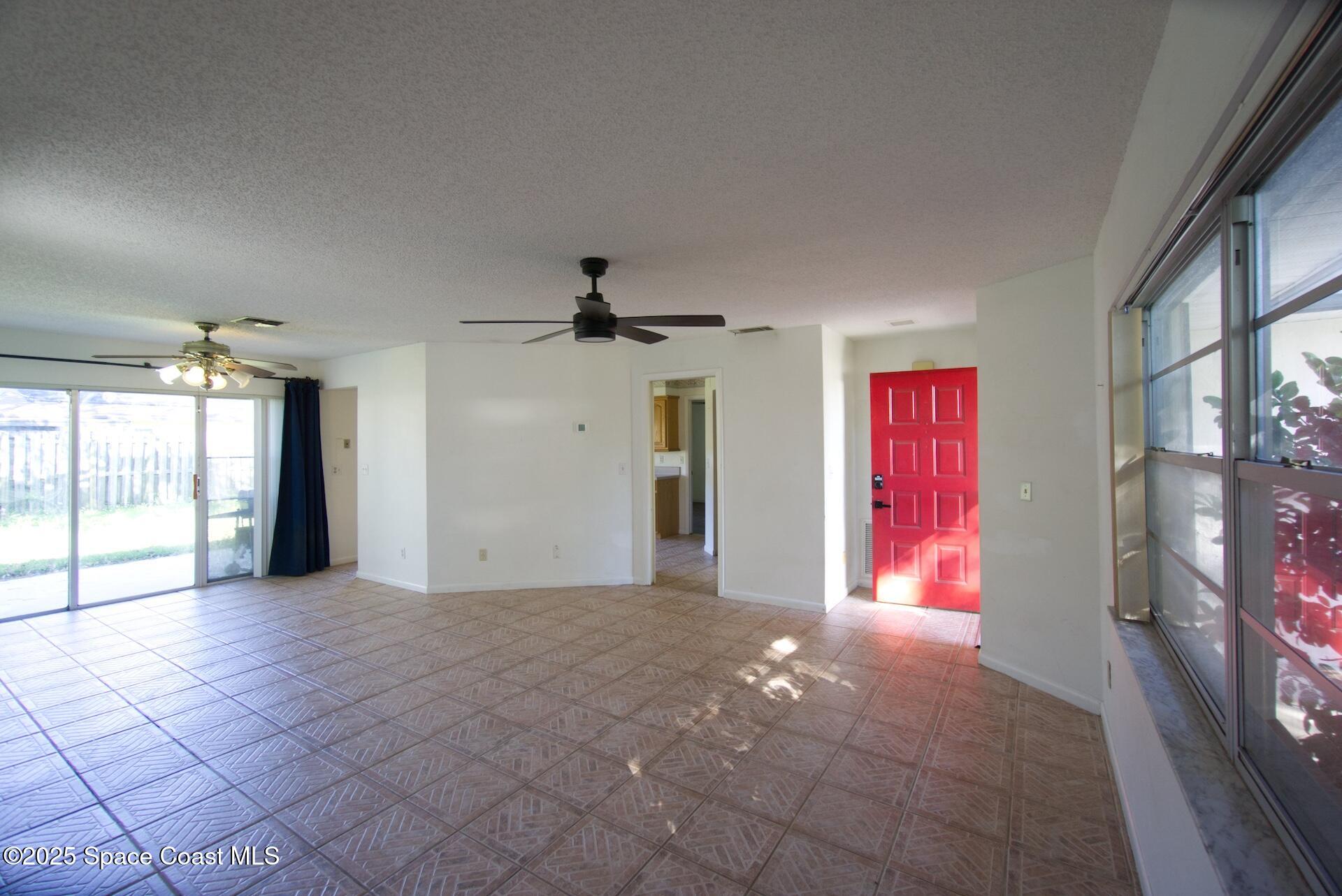 1980 Talloak Road Melbourne, FL 32935 - Photo 13 of 13 a view of empty room with windows