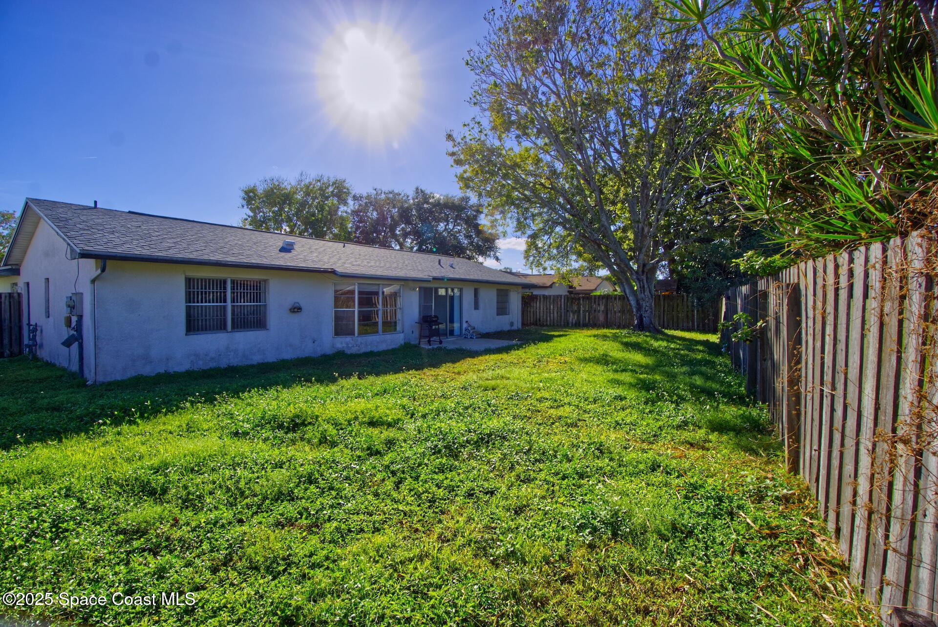 1980 Talloak Road Melbourne, FL 32935 - Photo 3 of 13 a view of a house with a back yard