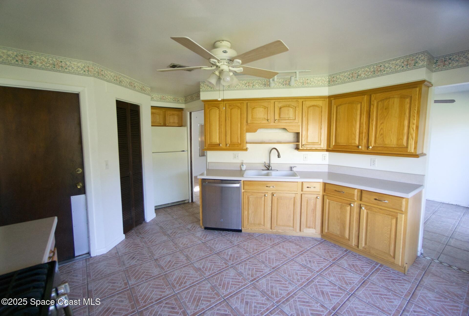 1980 Talloak Road Melbourne, FL 32935 - Photo 10 of 13 a kitchen with a sink stove and refrigerator