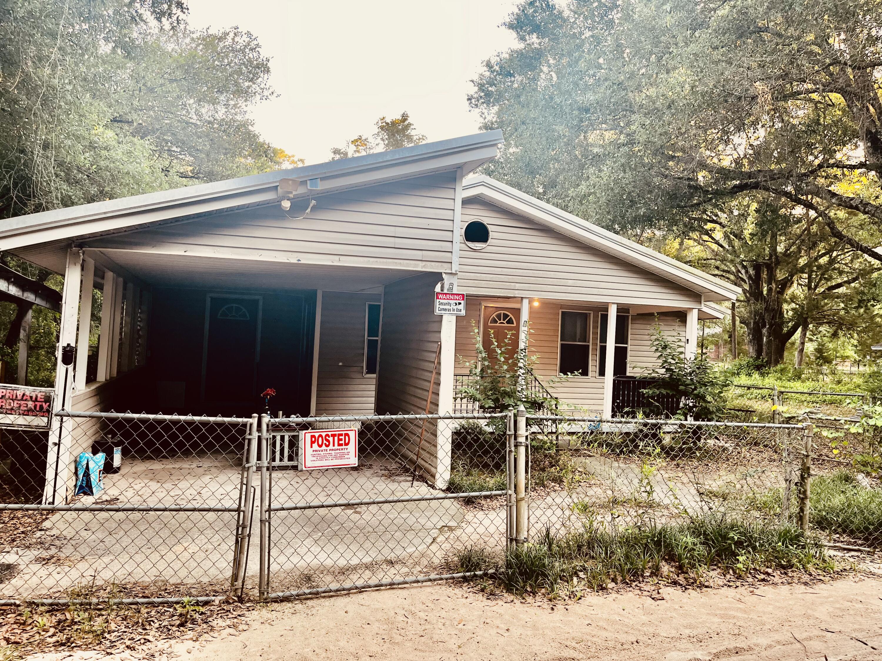 3040 Register Lane Crestview, FL 32539 - Photo 2 of 13 a backyard of a house with table and chairs