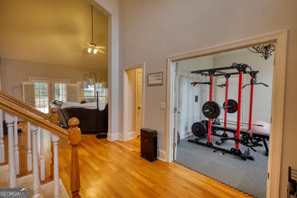 a room with kitchen island granite countertop a sink cabinets and a large window