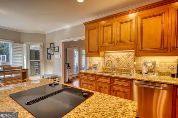 a kitchen with stainless steel appliances granite countertop a sink stove and microwave