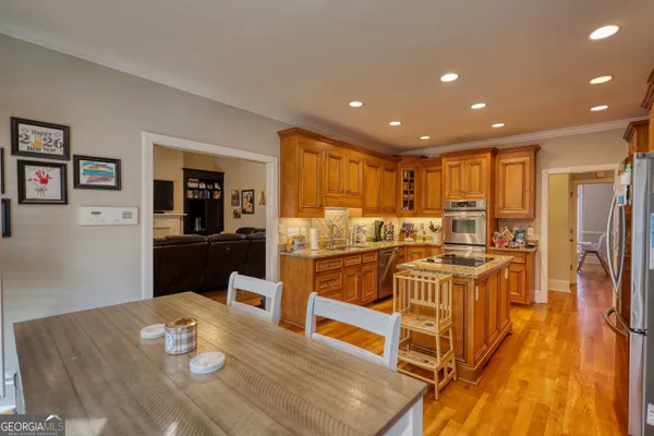 a large kitchen with lots of counter top space and stainless steel appliances