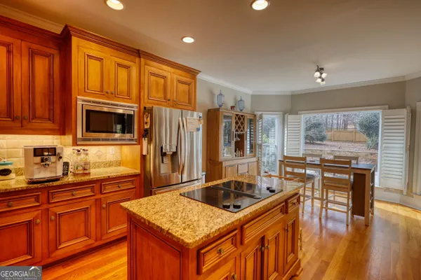 a kitchen with stainless steel appliances granite countertop a sink stove and refrigerator