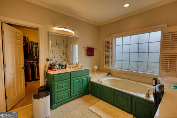 a view of walk in closet with clothes