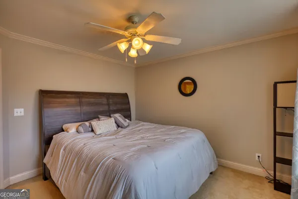 a bedroom with a large bed and a chandelier