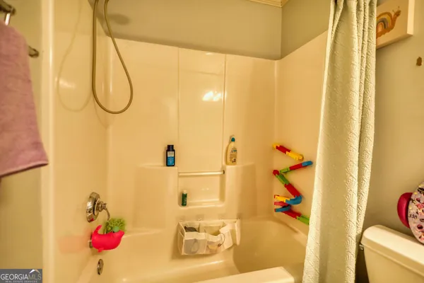 a bedroom with bed and a chandelier