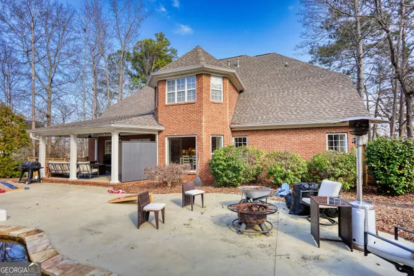 a view of a patio with table and chairs under an umbrella