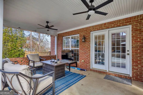 a view of a house with backyard and sitting area
