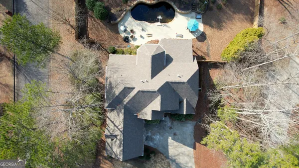 a view of a patio with dining table and chairs under an umbrella