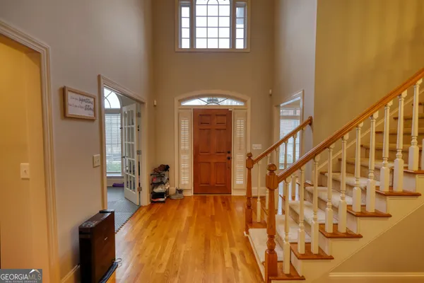 a view of an entryway with wooden floor and stairs