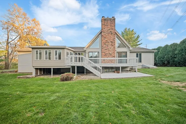 a view of a house with a yard and sitting area