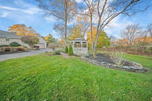 a view of a livingroom with wooden floor a fireplace and windows