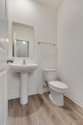 a bathroom with a sink toilet and a mirror