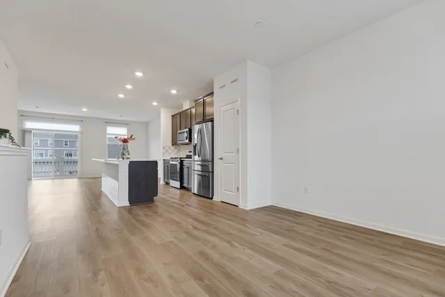 a view of kitchen with furniture and wooden floor