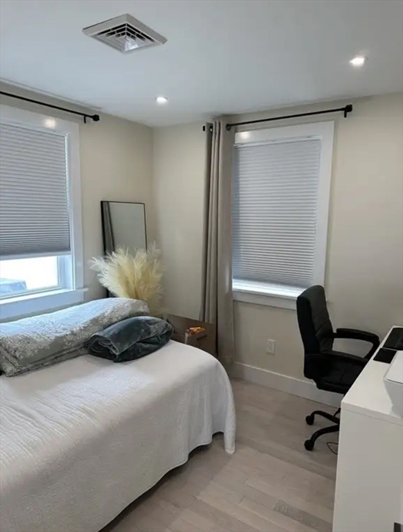 65 Louis Street, Unit A Barnstable, MA 02601 - Photo 11 of 15 a bedroom with a bed and a chair