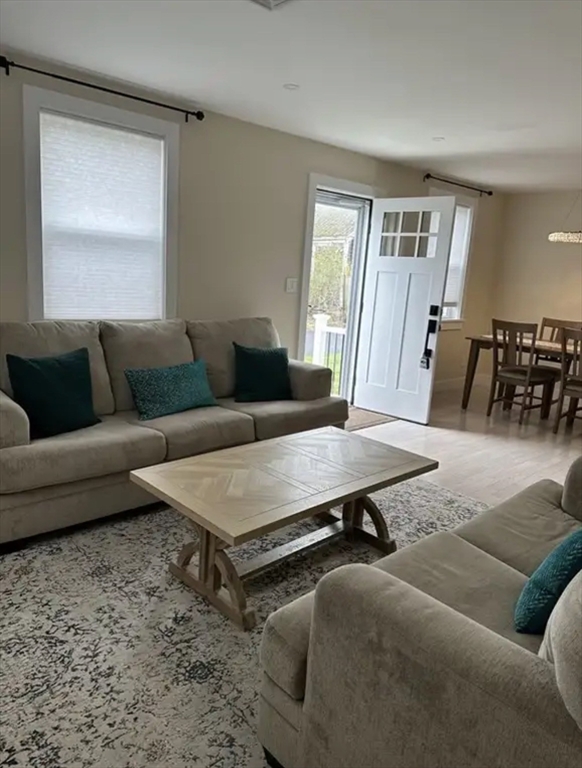 65 Louis Street, Unit A Barnstable, MA 02601 - Photo 13 of 15 a living room with furniture and wooden floor