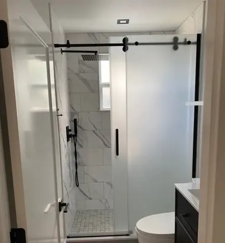a bathroom with a shower and a toilet